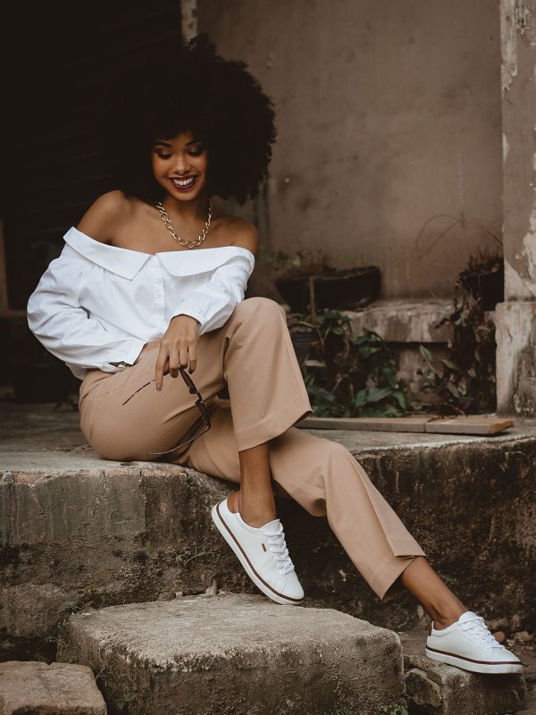 photo-of-smiling-woman-sitting-on-concrete-block-posing-2873674